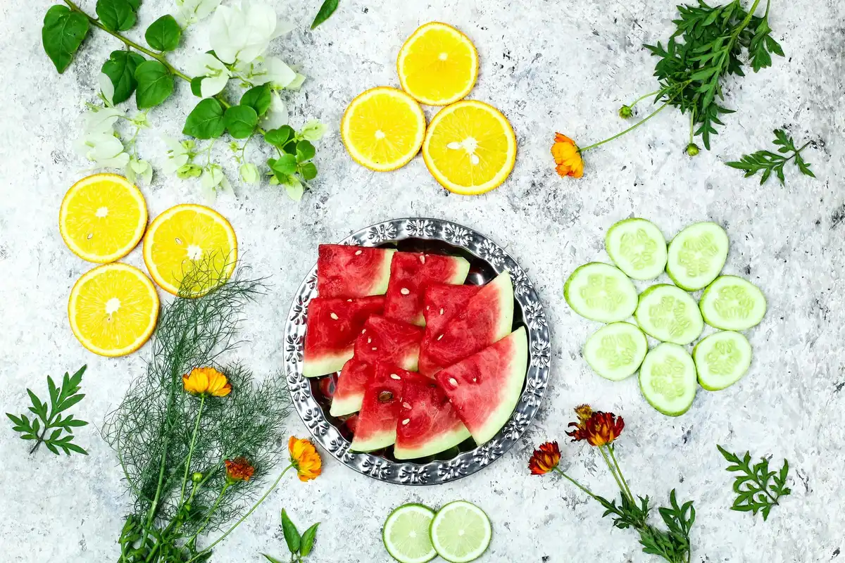 Assortment of high-water fruits and vegetables including cucumber, watermelon, tomatoes and strawberries