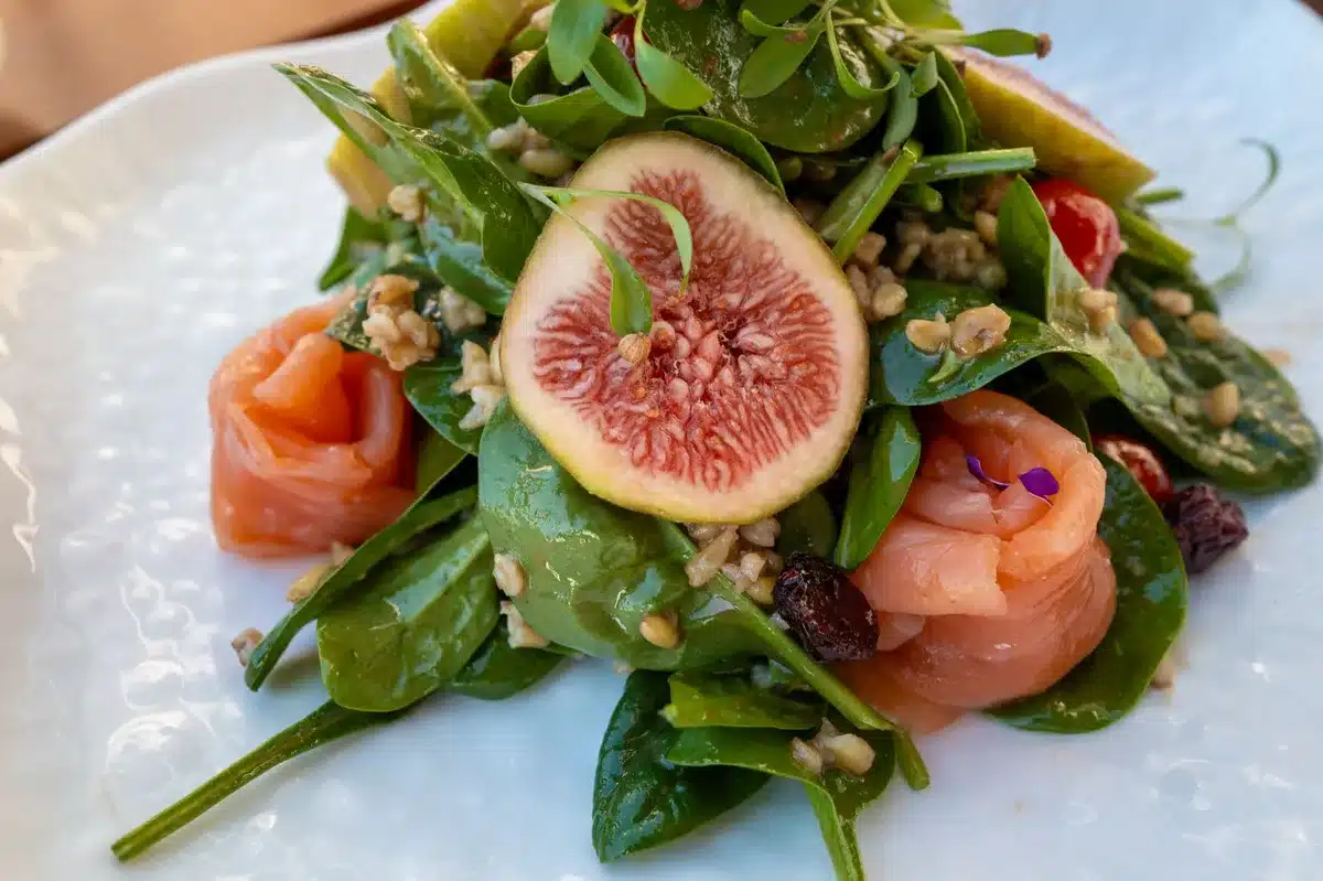 Assortment of heart-healthy foods including fatty fish, nuts, seeds, and vegetables