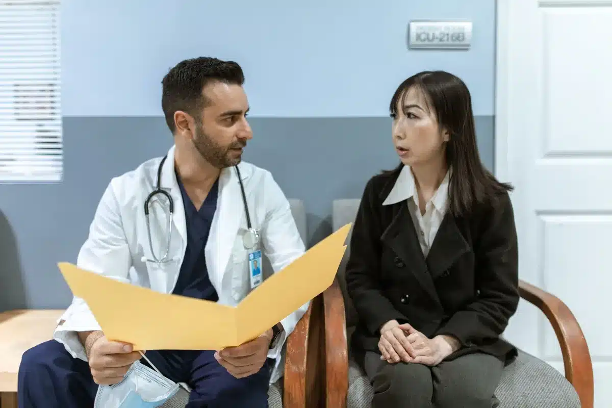 A person in conversation with a healthcare professional during a medical consultation