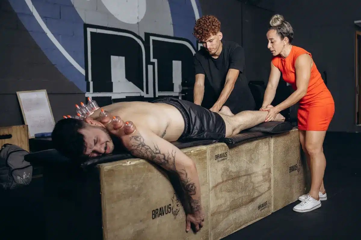 Sports medicine professional monitoring an athlete during training and recovery.