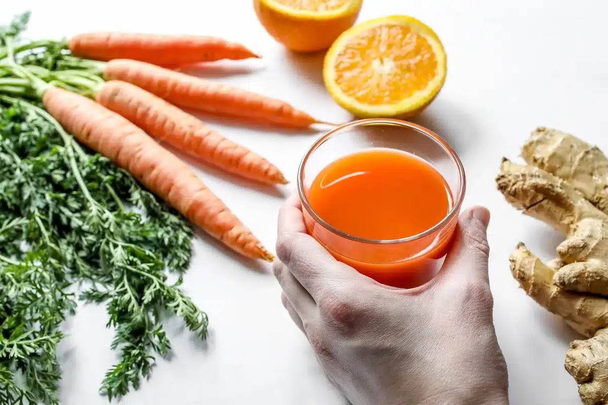Colorful fresh ingredients for immunity-boosting juices including citrus, ginger, and vegetables.
