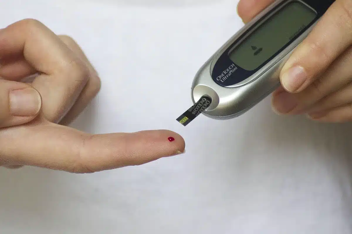 Blood glucose meter and diabetes management supplies on a medical desk.
