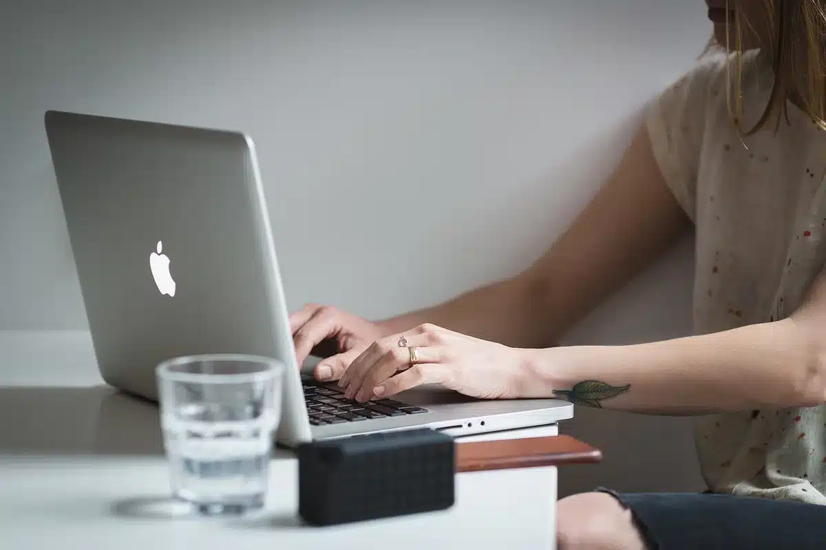 Researcher reviewing medical reports on a laptop in daylight