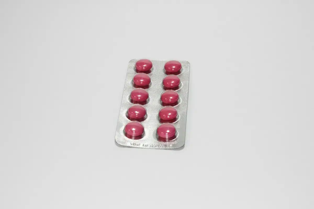Oral blister pack on a clinic table beside a consultation folder