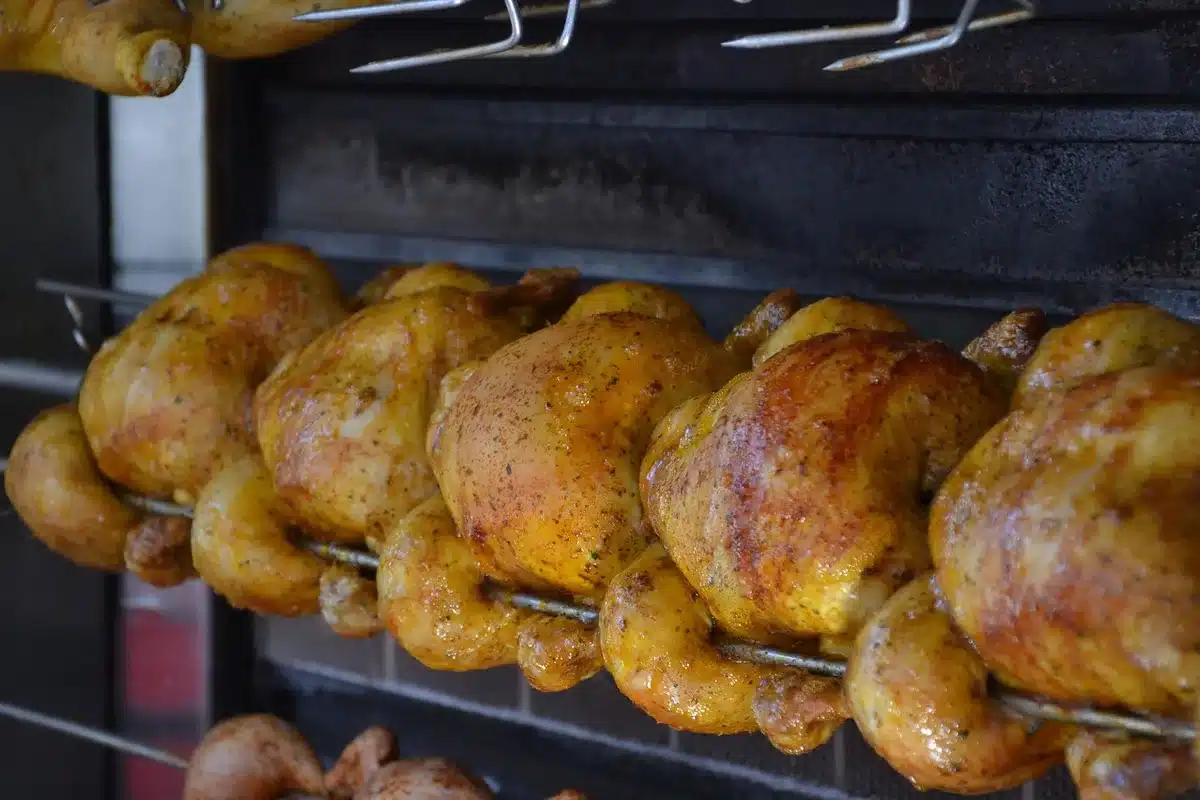 Fresh chicken gizzards on a market counter with paper lining