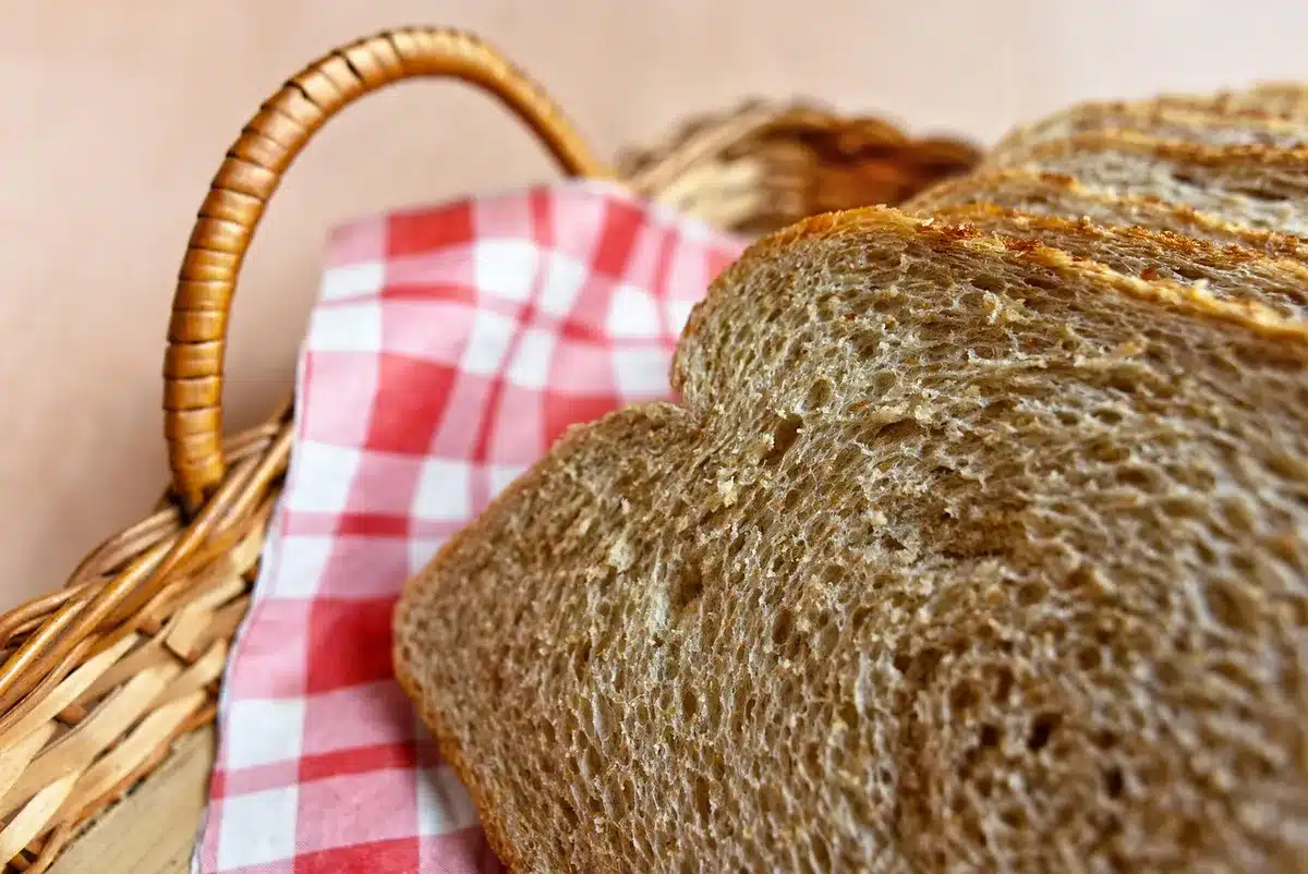 Sliced bread on a plate near a nutrition book, illustrating health benefits