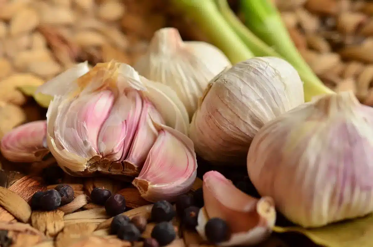 Chopped garlic cloves on a board showing preparation to activate allicin